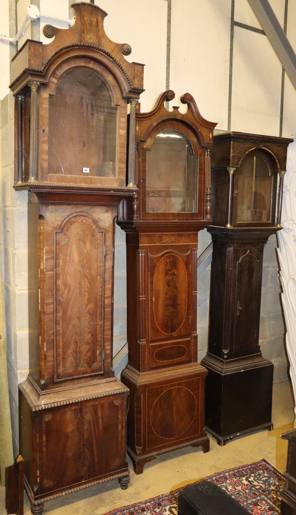Three George III mahogany and oak longcase clock cases, largest W.56cm, D.34cm, H.254cm